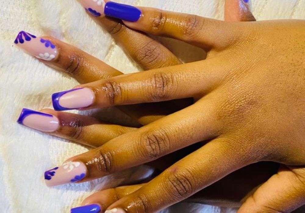 Close-up of professional nail art being applied in a clean and stylish salon setting.